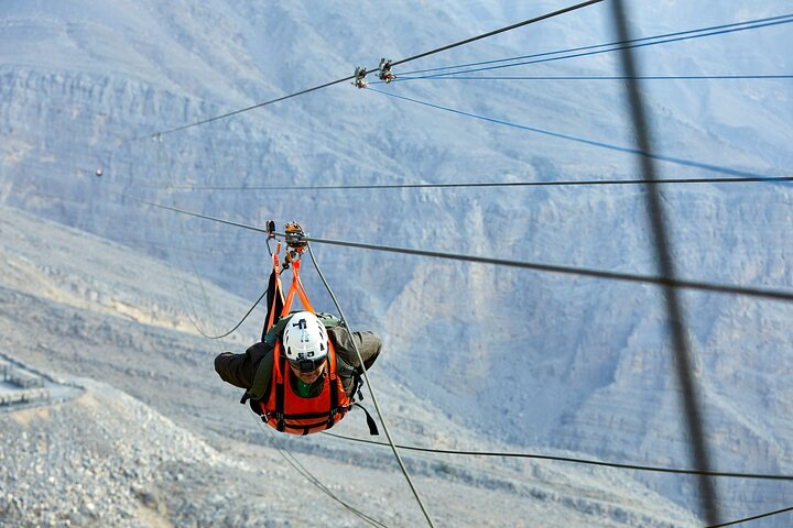 Soar above majestic Jebel Jais feeling the rush as you zipline over stunning mountain landscapes. Experience breathtaking views from unparalleled heights in the UAE. Adventure awaits!